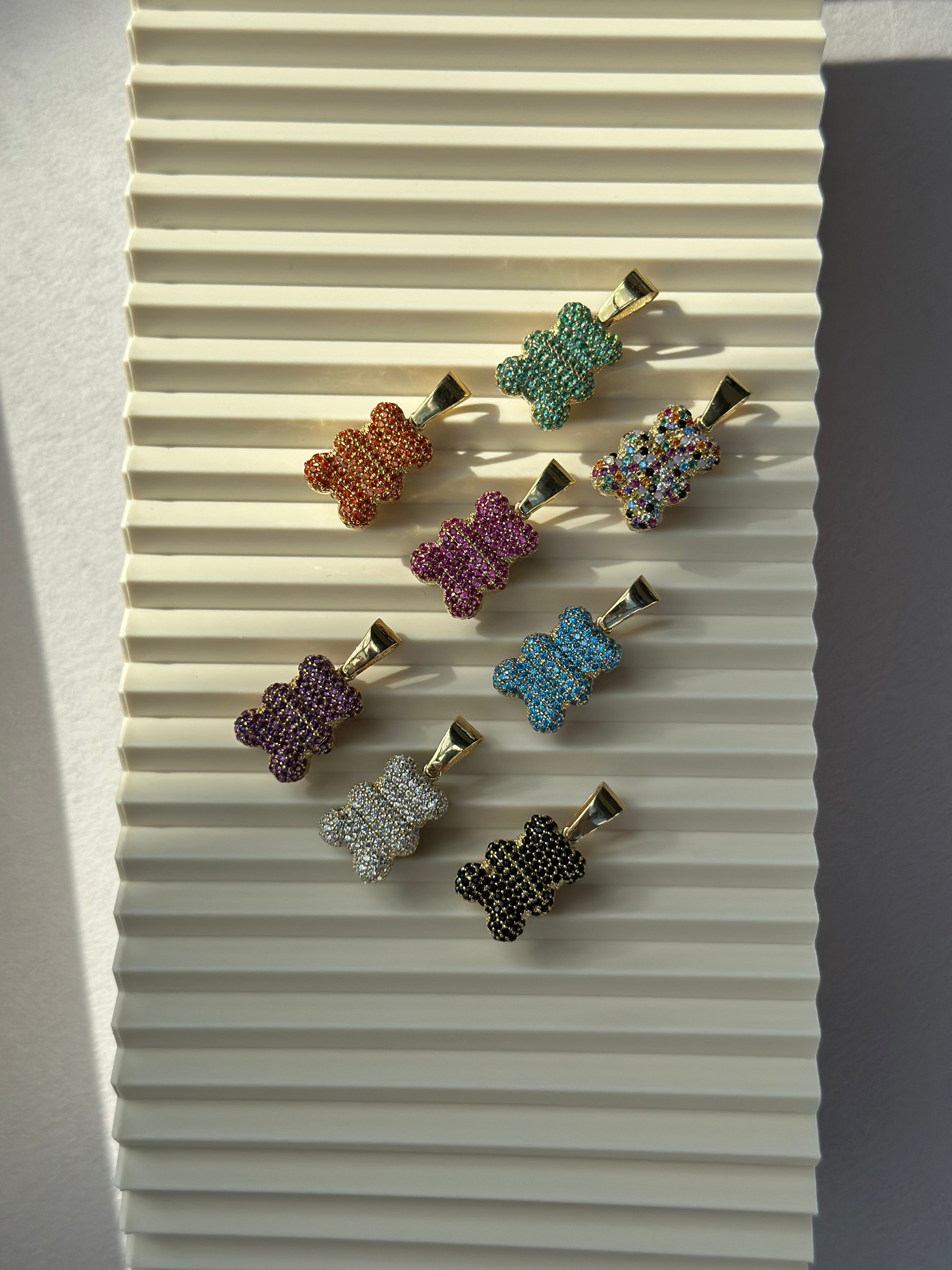 Bunte Glitzer Bärchen Anhänger in Gold mit Zirkonia in vielen Farben auf hellem Hintergrund.