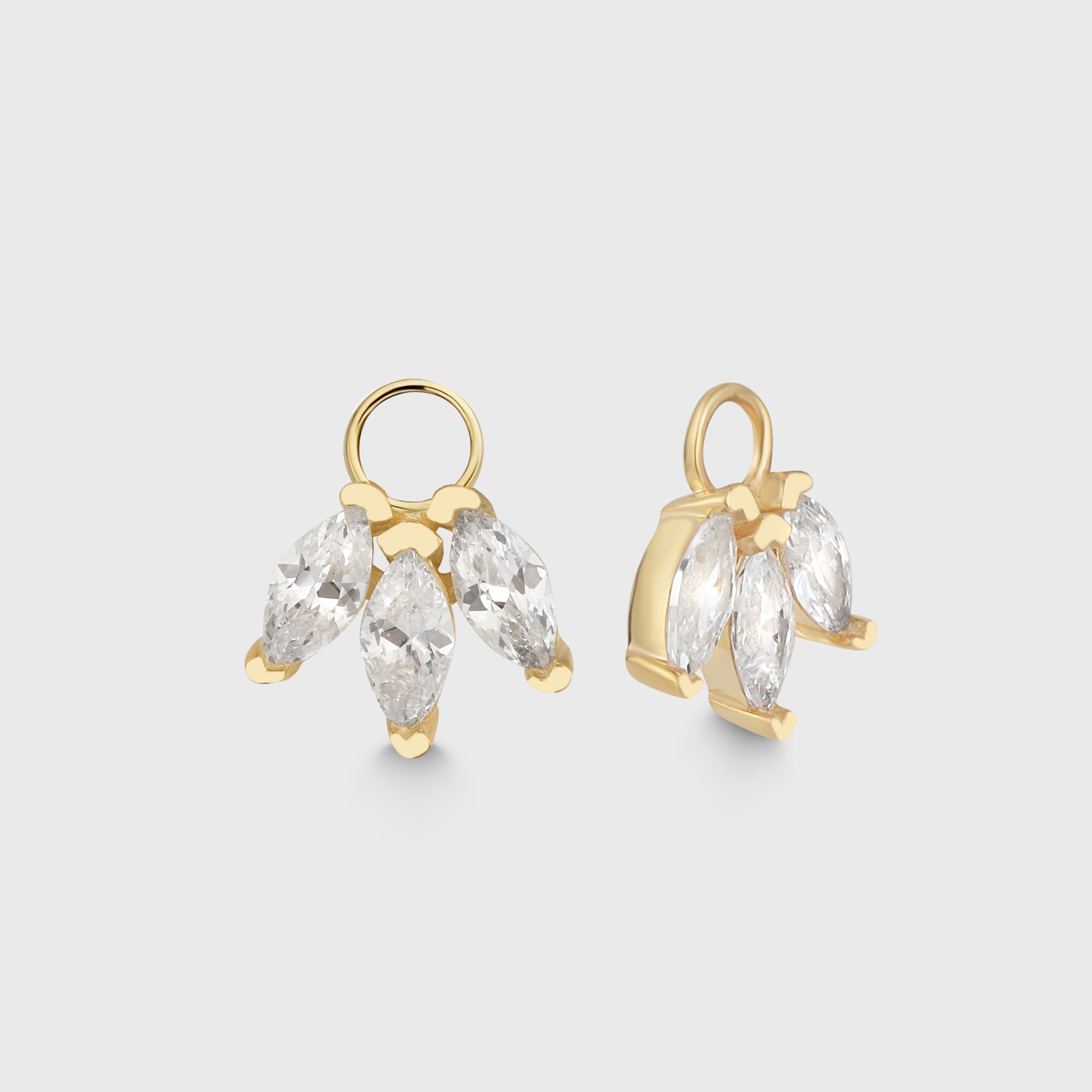 Goldener Charm Lotus mit drei klaren Zirkonia-Steinen als Anhänger für Creolen, frontal fotografiert vor hellem Hintergrund.