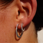 Creolen ONE Line Pavé L in Silber am Ohr getragen, funkelnde Pavé-Zirkonia, elegante Hoop-Optik.