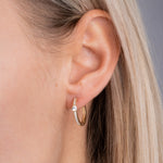 Am Ohr (Close-up): Kleine Creolen Solitaire Pavé Gold – wasserfest, nickelfrei, Zirkonia-Glanz am Ohr.