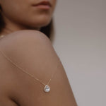 Drops Halskette mit Zirkonia Steinen in Gold an der rechten Schulterseite getragen – zarter Tropfen-Anhänger.