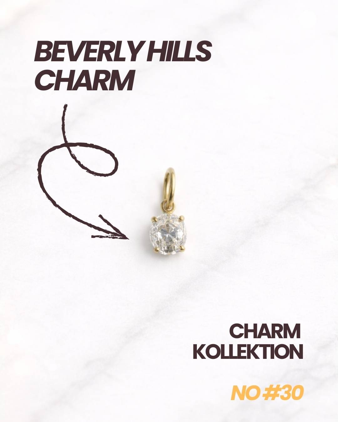 Goldener Beverly Hills CHARM mit funkelndem Stein auf hellem Hintergrund.
