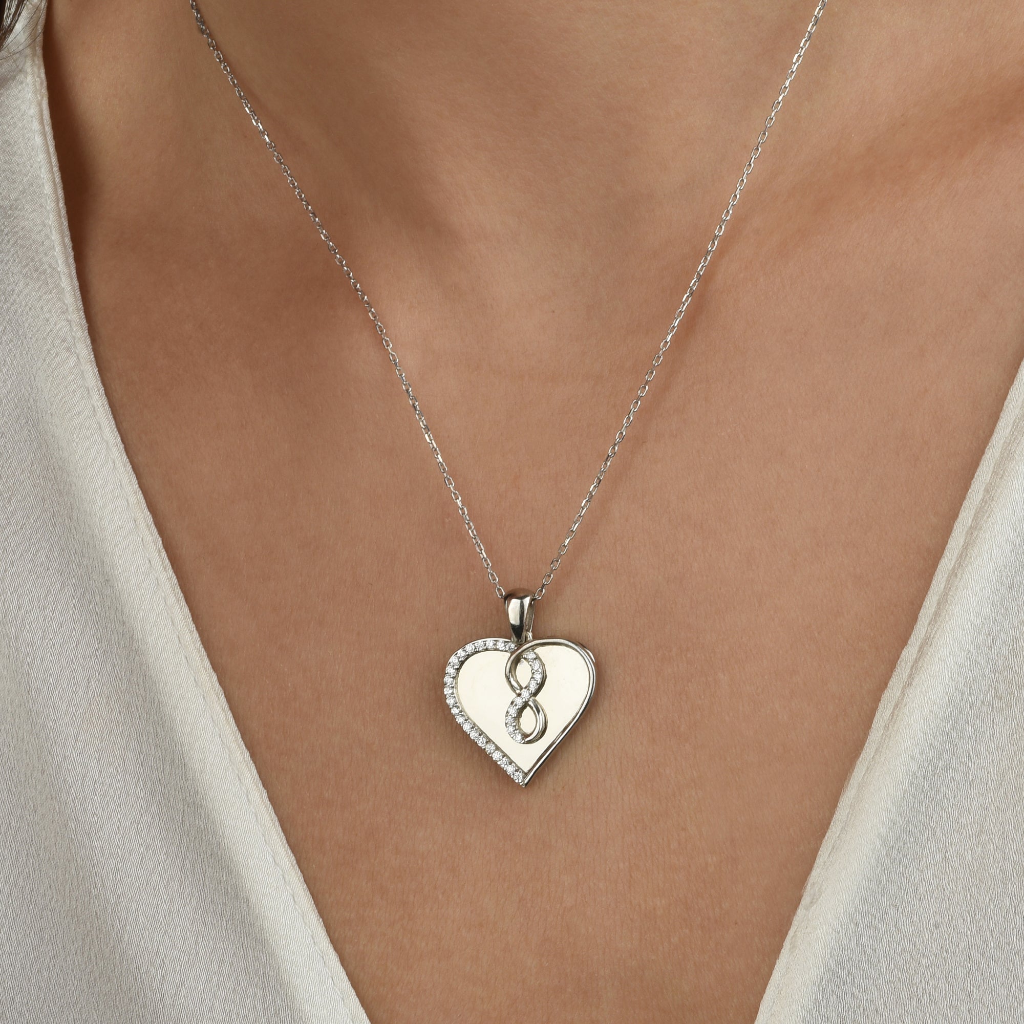 Infinity Love Halskette Rosé vergoldet, getragen auf Dekolleté, edles Symbol für Liebe und Verbundenheit