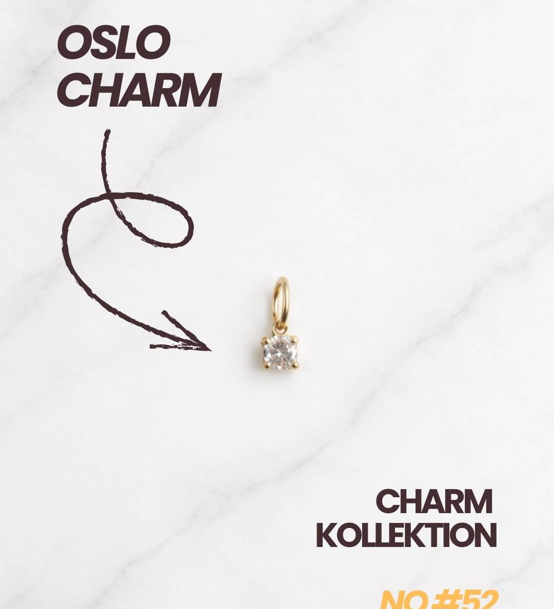 Oslo Charm Kollektion mit goldenem Kristall Charm auf elegantem Hintergrund.