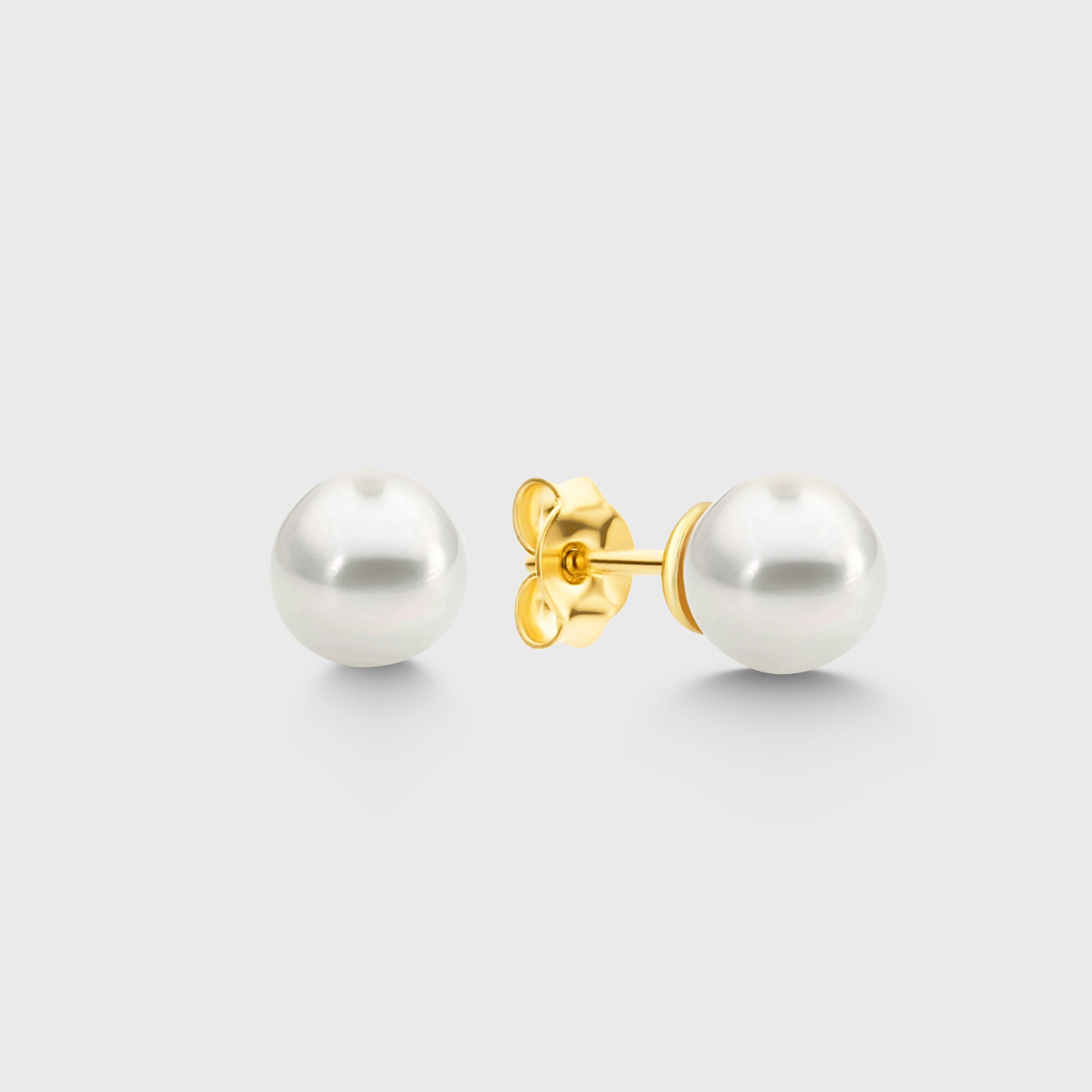 Pearl Balls L Stud Perlen Ohrstecker mit goldfarbenem Stecker auf hellem Hintergrund, runde weiße Perle.