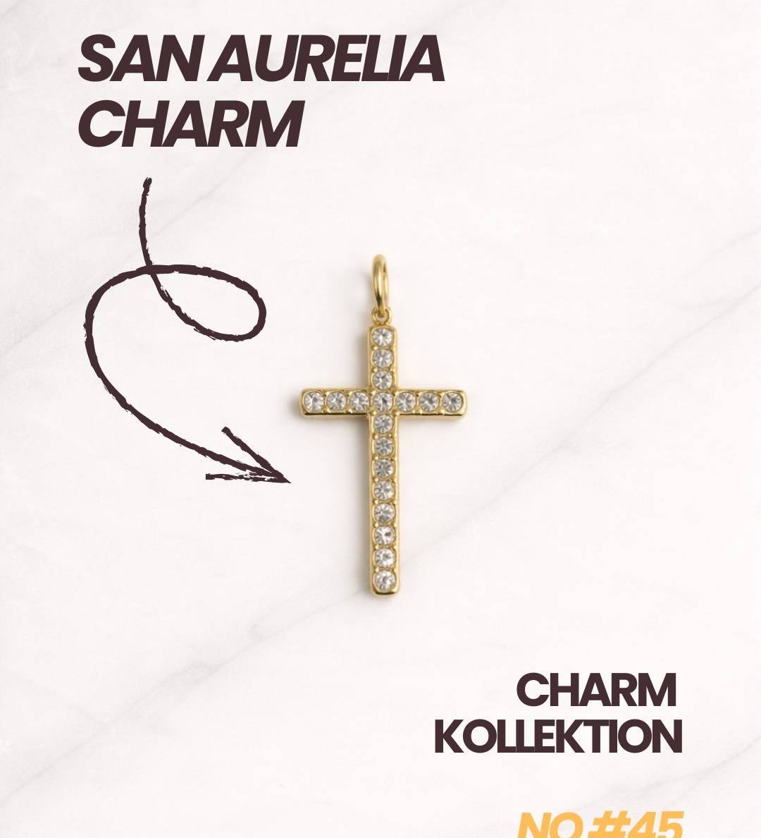 San Aurelia Charm Kollektion mit goldenem Kreuz-Charm und modernem Schriftlayout.
