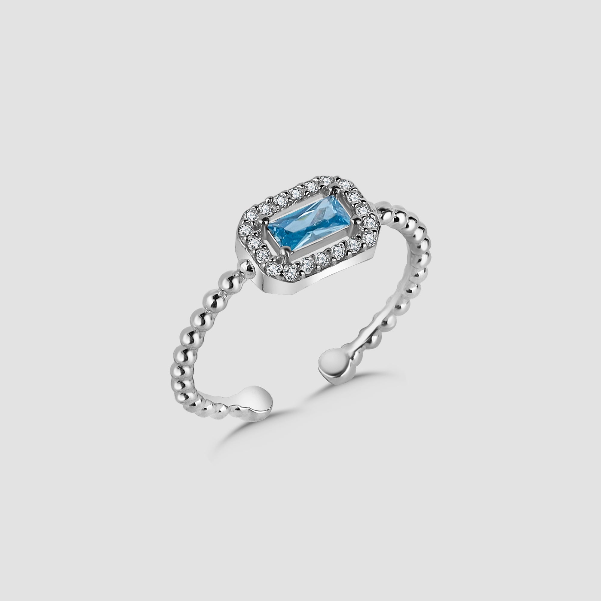 Silberner Baguette Light Blue Ring mit hellblauem Stein und Zirkonia-Halo von Dkeniz.