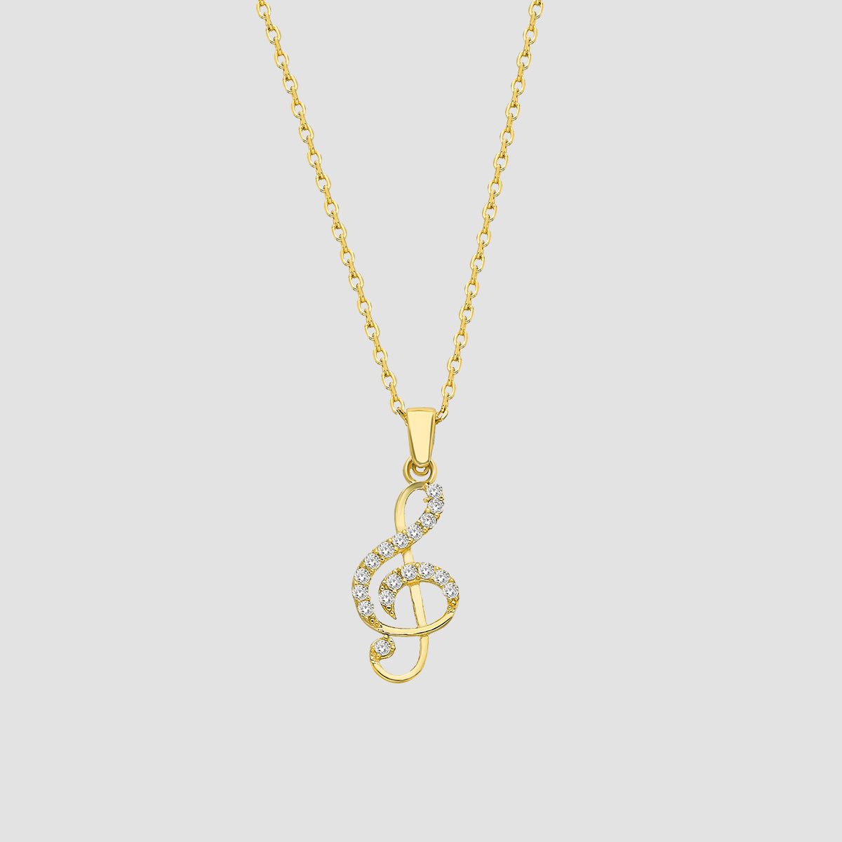 Notenschlüssel Kette in Gold mit weißen Zirkonia, freigestellt auf grauem Hintergrund.