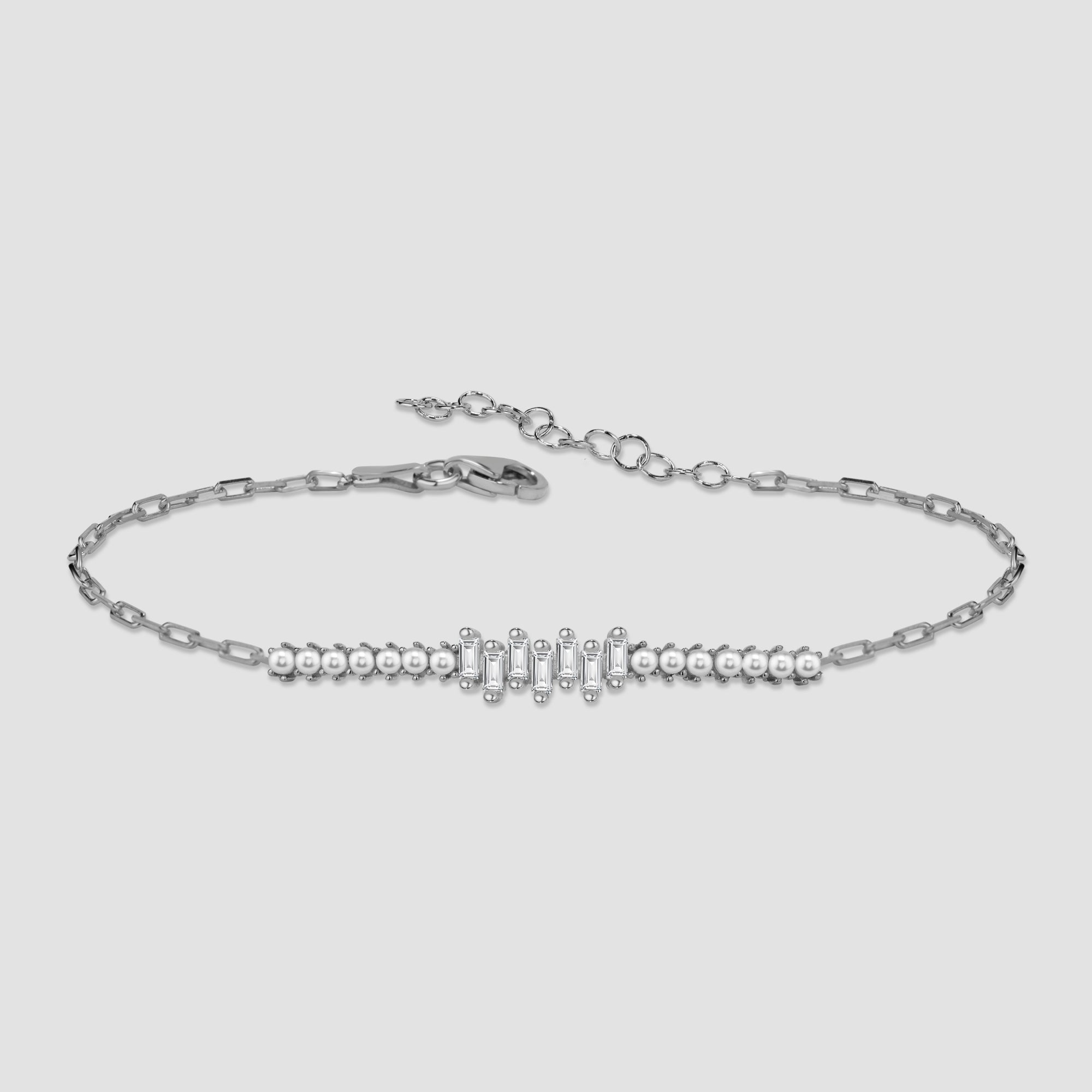 Pearl X Baguette Armkette in Silber mit Perlen und Baguette-Zirkonia auf hellem Hintergrund.